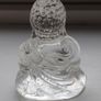 A glass Buddha figurine seated in the lotus position. Image 10
