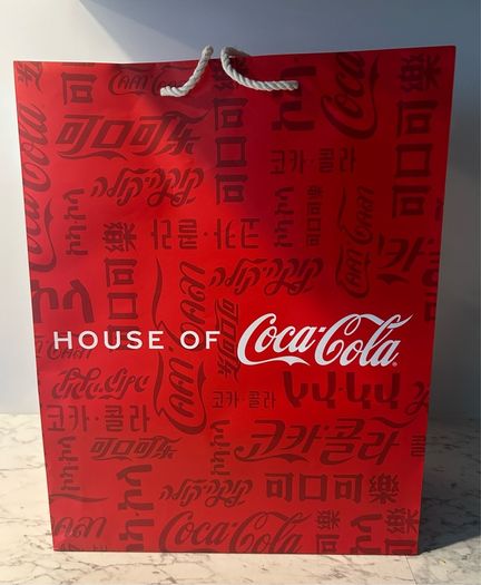 House of Coca-Cola Paper Gift Bag featuring white rope handles
