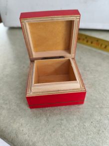 A small wooden trinket / gift box painted red with hand painted flower.