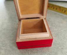 A small wooden trinket / gift box painted red with hand painted flower.