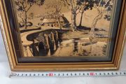 Lovely gold picture of bridge and boy in boat.