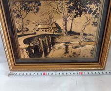 Lovely gold picture of bridge and boy in boat.