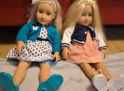 Two Our Generation dolls with outfits