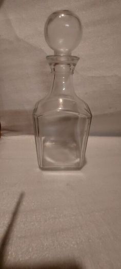 Art deco glass whiskey decanter with lid,,buyer collects or pays postage thank you, good patina condition,,sold as is, see pictures for condition,,