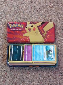 Pokemon tin and cards