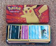 Pokemon tin and cards