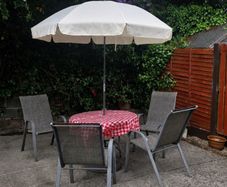 Garden table, 4 chairs & parasol