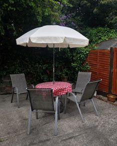 Garden table, 4 chairs & parasol