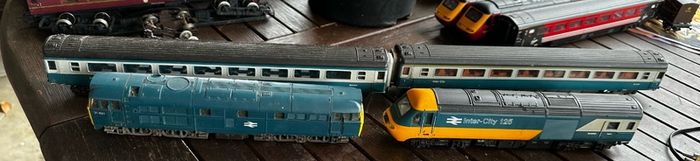 2 Hornby British rail engines and 2 British rail coaches. Don't have a controller so don't know if they work or not Hornby train