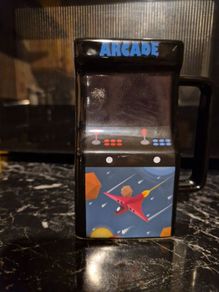 Retro Arcade Heat-Changing Mug, a novelty ceramic coffee mug shaped like a classic 1980s tabletop arcade cabinet