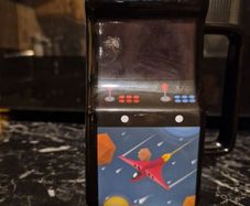 Retro Arcade Heat-Changing Mug, a novelty ceramic coffee mug shaped like a classic 1980s tabletop arcade cabinet