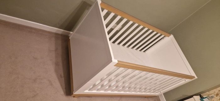 White and wooden cot