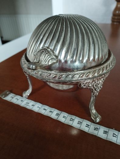 A vintage silver-plated butter dish or caviar bowl with a three-legged lid.