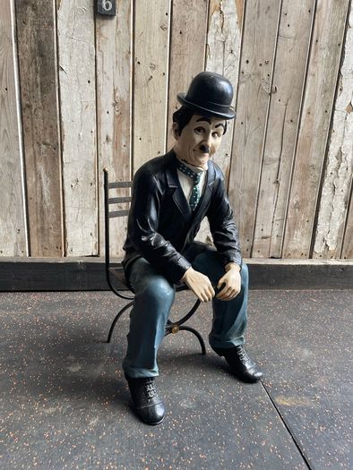 Charlie Chaplin resin sculpture figurine in metal chair