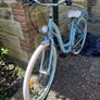 This is a B'TWIN Elops city bike, a fully-equipped urban commuter in a light blue color. Image 2