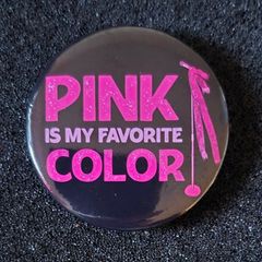 Pink , pin back button badge.