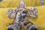 A sitting clown with dog ornament