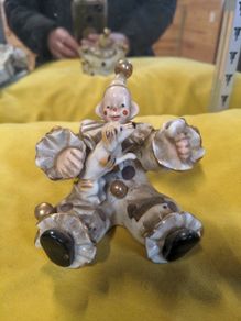 A sitting clown with dog ornament