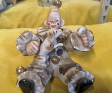 A sitting clown with dog ornament