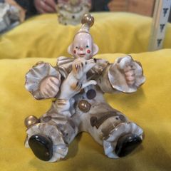 A sitting clown with dog ornament