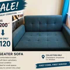 Grey fabric sofa bed with large storage compartment.