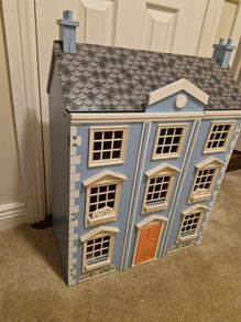 Wooden dolls house with furniture