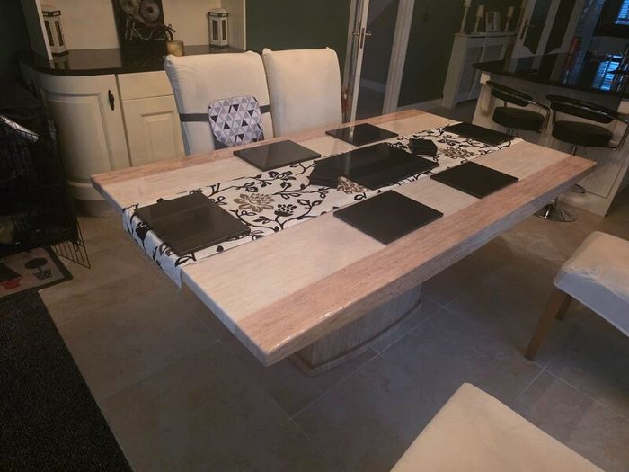 Marble table with 4 cream leather chairs