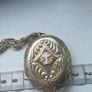 A large medallion featuring religious symbols, suspended from a long chain. Image 9