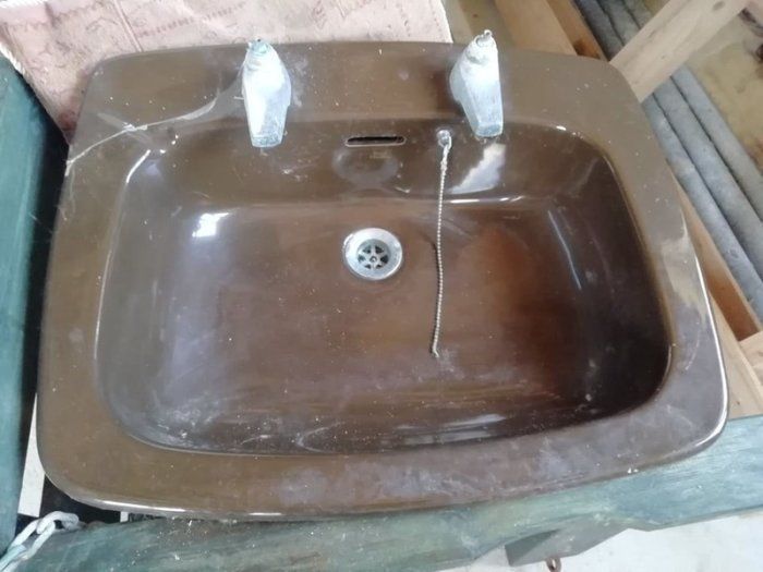 Cast iron brown bath with fittings, brown Royal Dalton toilet and cistern, brown wash hand basin with taps.