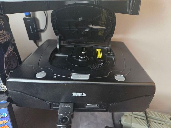 Sega Saturn w/ 3D Control Pad, Arcade Racer, Lightgun and Games