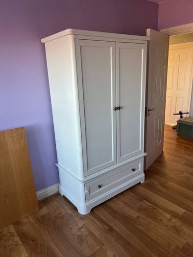 White double door high wardrobe with bottom drawer and shelf