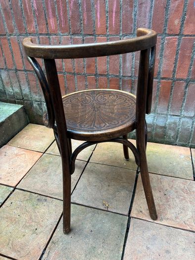 A vintage 1920s Thonet style bentwood chair with armrests.