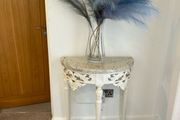 ornate half-moon console table with a granite top