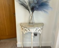 ornate half-moon console table with a granite top