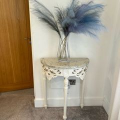 ornate half-moon console table with a granite top