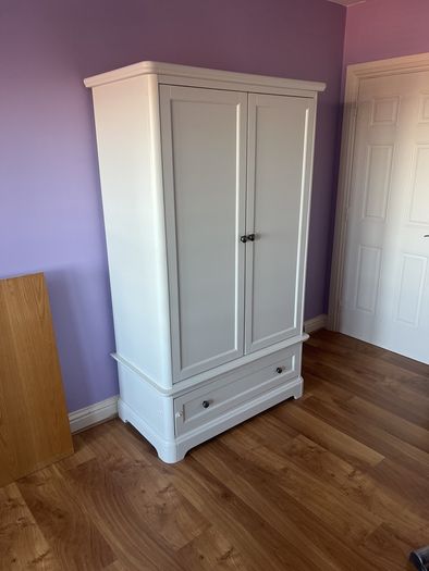 White double door high wardrobe with bottom drawer and shelf