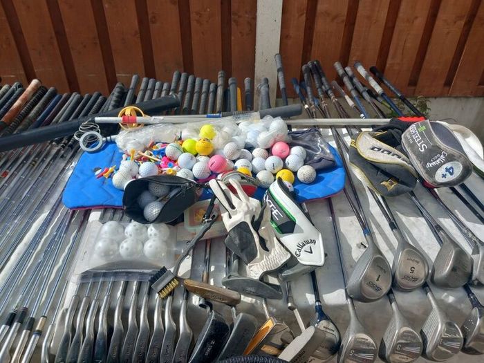 A selection of Golf clubs. Bags and golf balls.