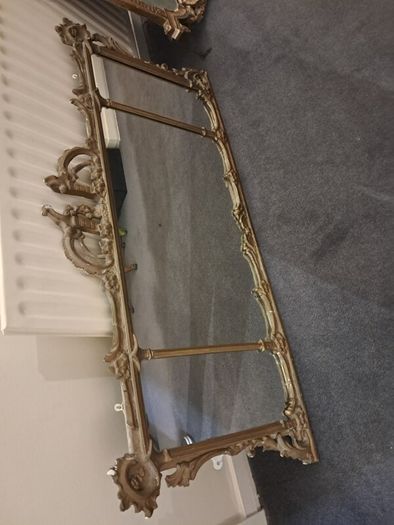 Two distinct antique giltwood mirrors with elaborate French-style ornamentation