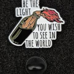 Be the light,  pin back badge.