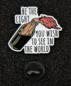 Be the light,  pin back badge.