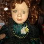 Vintage Large Victorian-style collectible Porcelain Doll featuring curly reddish-brown hair and a multi-layered emerald green satin and lace dress Image 2