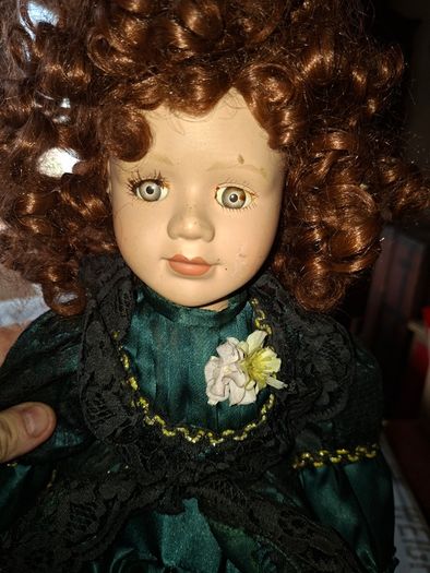 Vintage Large Victorian-style collectible Porcelain Doll featuring curly reddish-brown hair and a multi-layered emerald green satin and lace dress