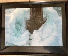 Framed picture of wave hitting lighthouse