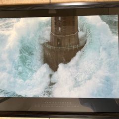 Framed picture of wave hitting lighthouse
