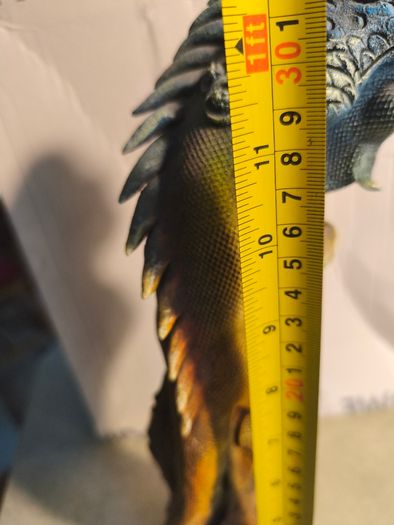 handmade iguana on natural wood log