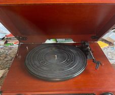 Record player for sale. Free Postage In perfect working order. New drive belt fitted plus 1 spare. New stylus fitted. 3 speed push button controls. AM/Fm radio. In a very nice red walnut case.