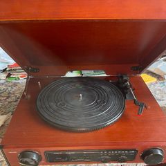 Record player for sale. Free Postage In perfect working order. New drive belt fitted plus 1 spare. New stylus fitted. 3 speed push button controls. AM/Fm radio. In a very nice red walnut case.