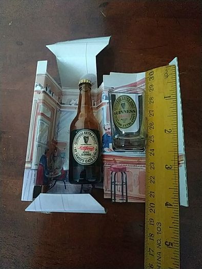 Guinness miniature bottle and glass.
