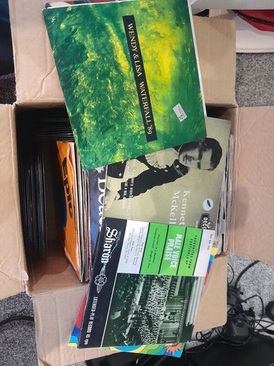 a box of 7" singles. 45 rpm vinyl records.