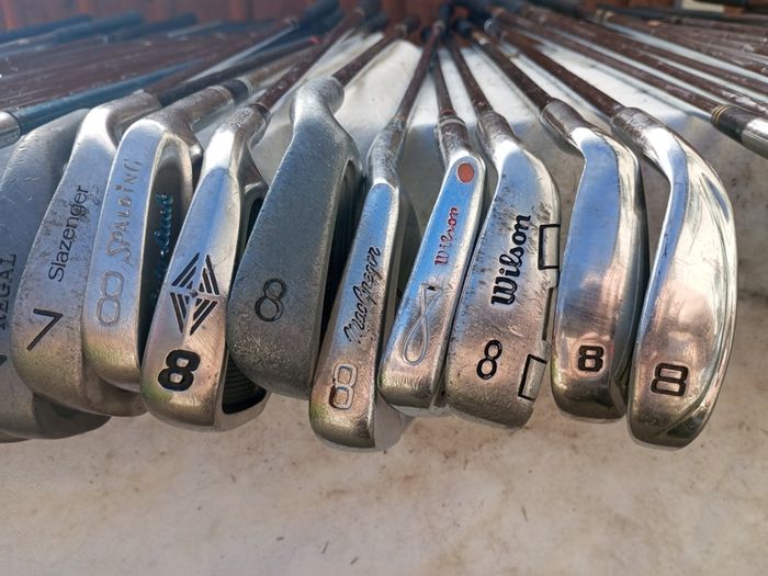 A selection of golf clubs and bags. All right handed clubs.